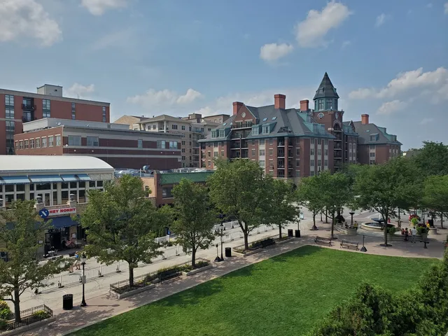 a view of a city with tall buildings and a big yard