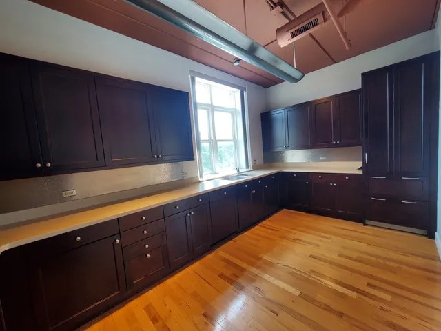 a kitchen with sink and cabinets