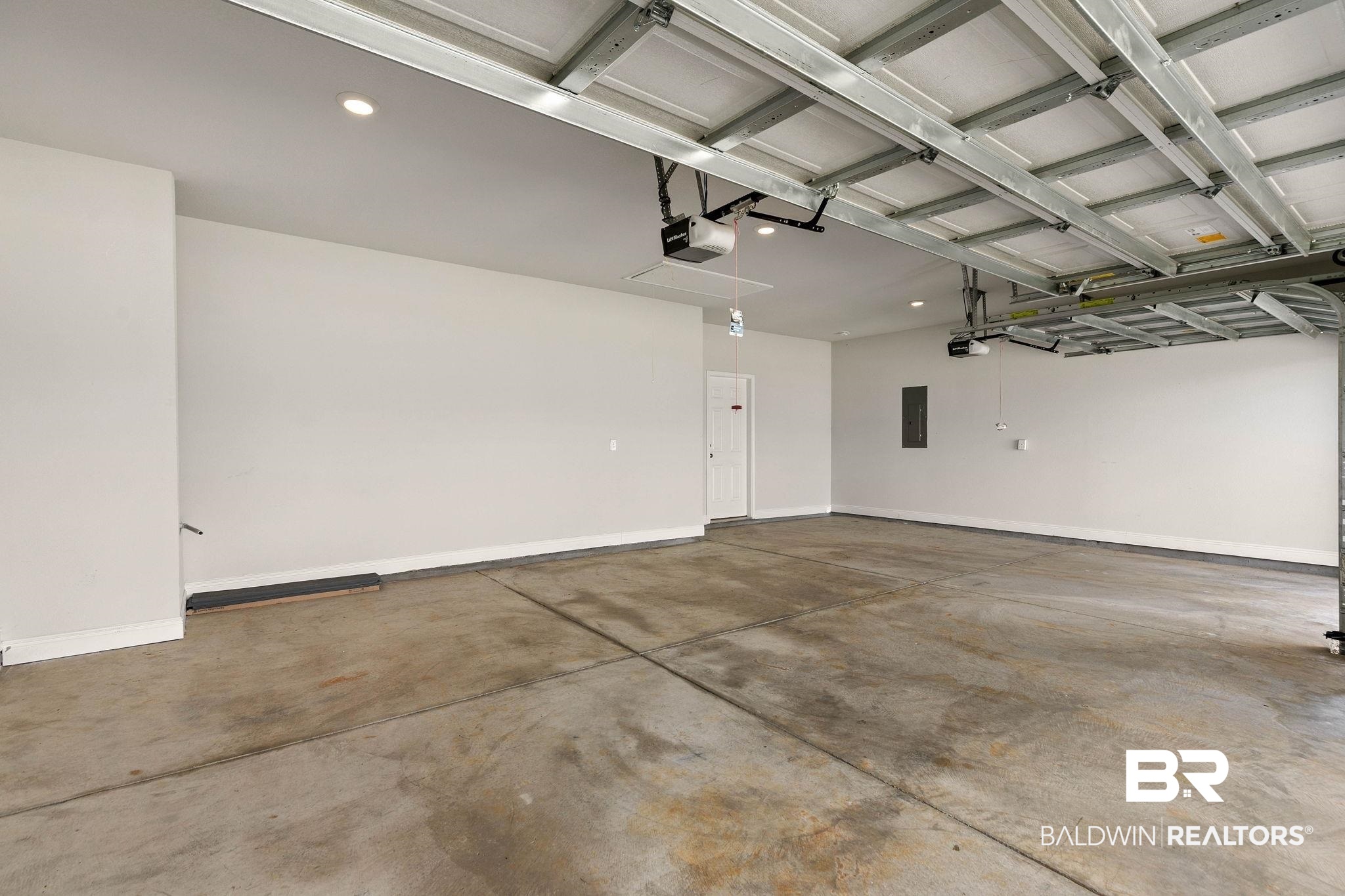9448 Amethyst Drive Daphne, AL 36526 - Photo 49 of 61 Garage with electric panel and a garage door opener