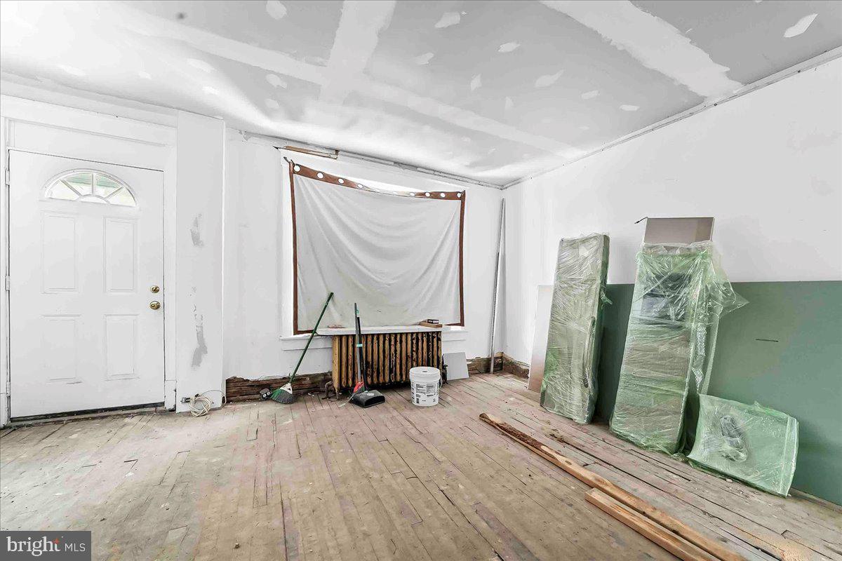 5536 Pine Street Philadelphia, PA 19143 - Photo 6 of 32 a view of a hallway with wooden floor and a mirror