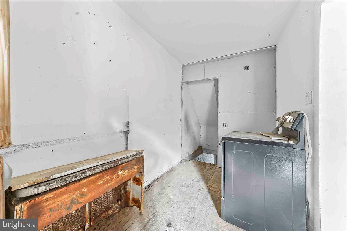 5536 Pine Street Philadelphia, PA 19143 - Photo 10 of 32 a bathroom with a granite countertop sink a mirror and shower