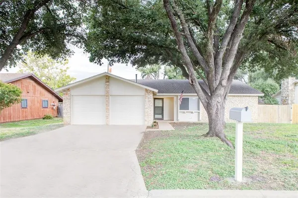 a front view of house with yard and trees
