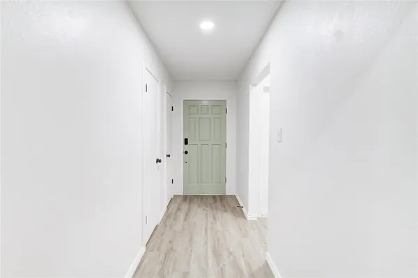 a view of a room with wooden floor