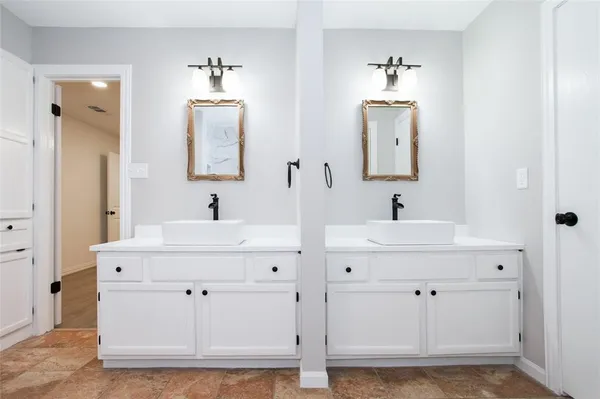 a bathroom with sink mirror and vanity