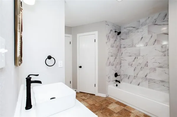 a bathroom with a bathtub and a shower