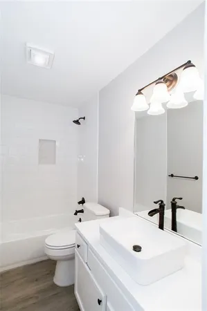 a bathroom with a sink a toilet and a mirror