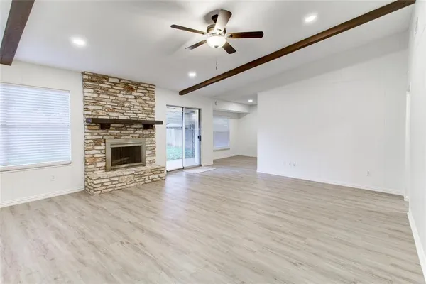 wooden floor in an empty room with a fireplace
