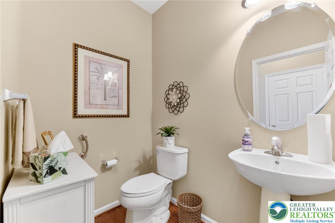 5440 Spring Ridge Drive West Macungie, PA 18062 - Photo 14 of 40 A well-appointed half bath features a pedestal sink and bright overhead lighting.