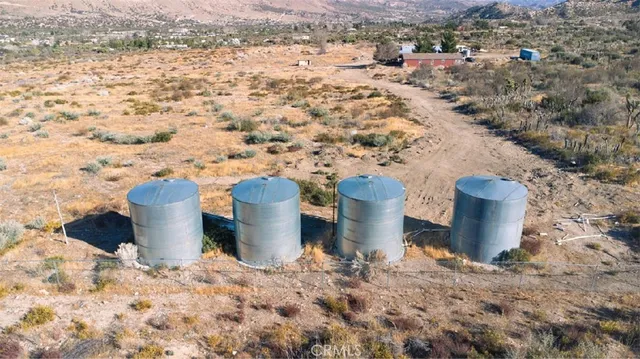 a living room with furniture pool table and stainless steel appliances