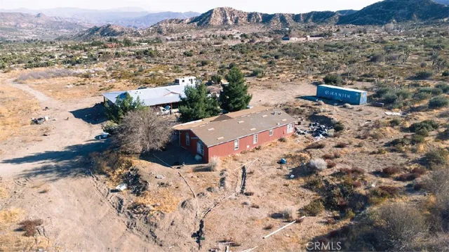 a view of a backyard of a house with a yard