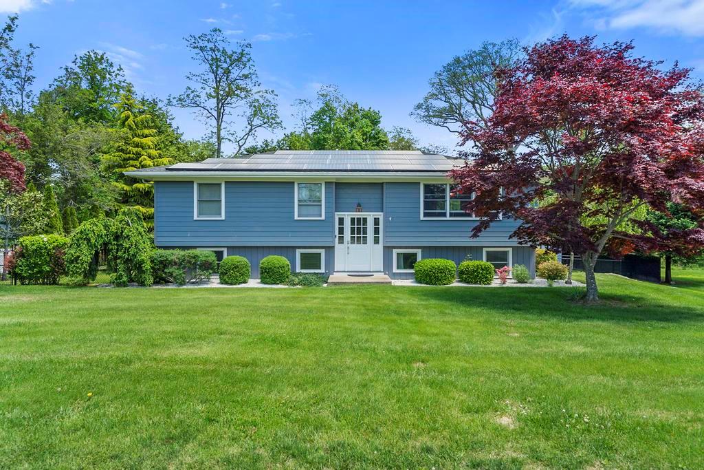 a front view of house with yard and green space