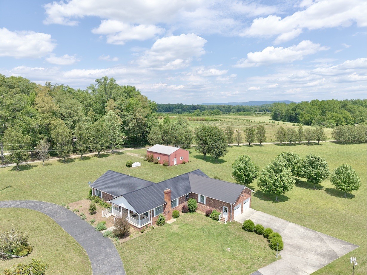 4929 Fountain Grove Road Morrison, TN 37357 - Photo 2 of 33 an aerial view of a house with a garden and lake view