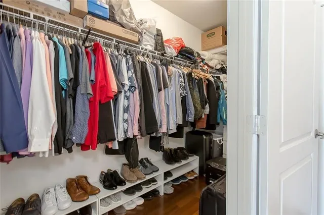 a view of walk in closet with clothes
