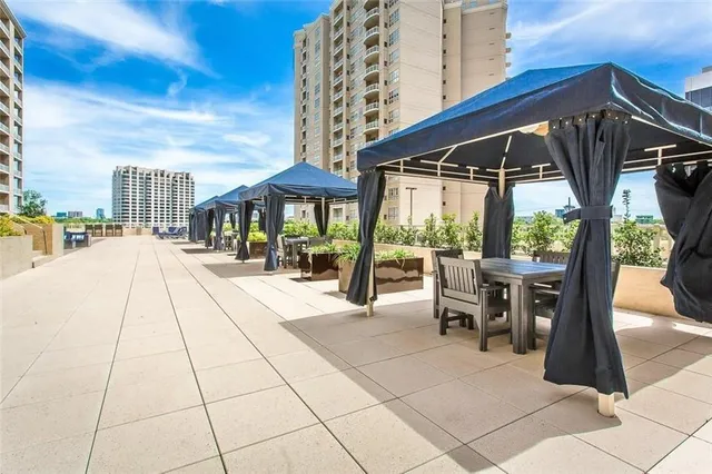 a view of a patio with a table and chairs under an umbrella