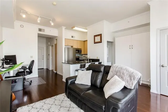 a living room with furniture and a wooden floor