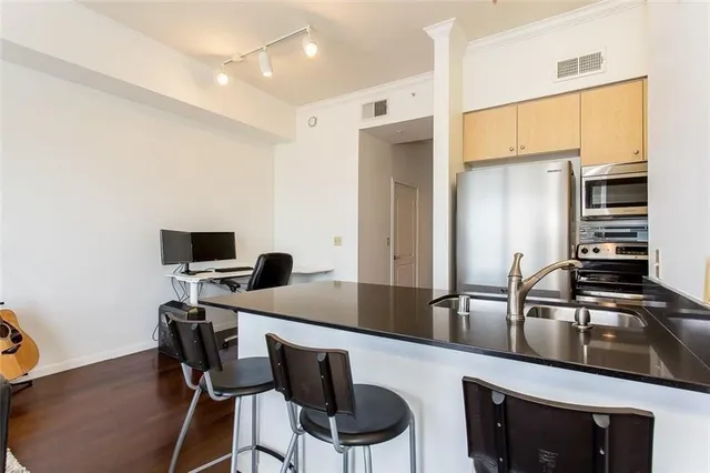 a kitchen with a sink cabinets and stainless steel appliances