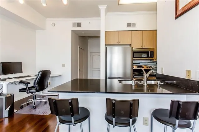 a kitchen with a sink cabinets and refrigerator