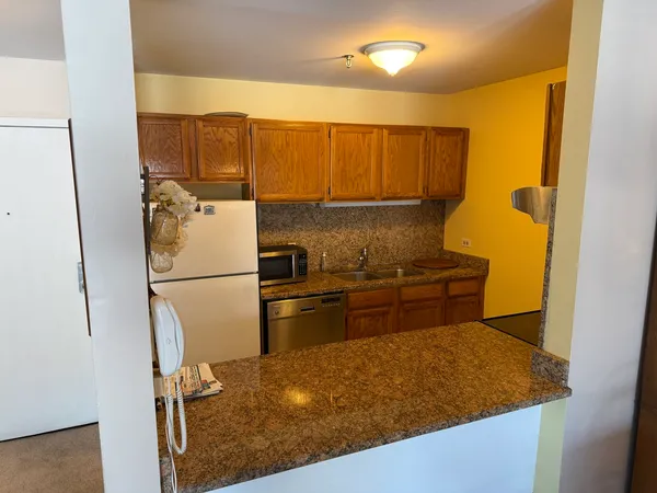 a kitchen with a refrigerator sink and stove