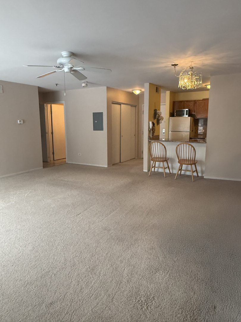 3265 Kirchoff Road, Unit 116 Rolling Meadows, IL 60008 - Photo 5 of 10 a view of an empty room with a window