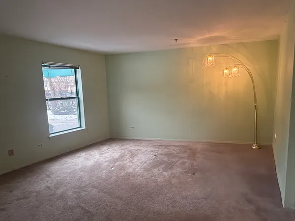 an empty room with windows and closet