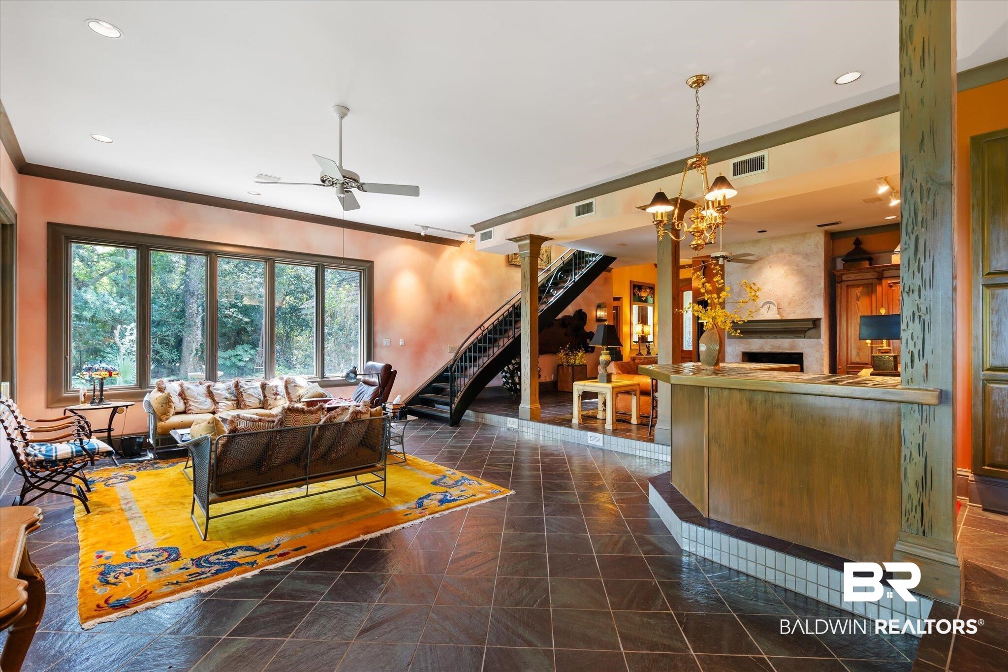 3325 Riviere Du Chien Road Mobile, AL 36693 - Photo 6 of 71 Living room featuring ceiling fan with notable chandelier and dark tile patterned floors