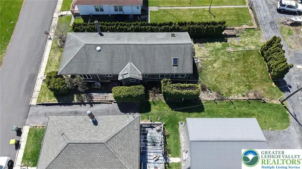 an aerial view of a house with yard swimming pool and outdoor seating