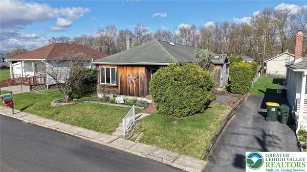 a view of house with yard and entertaining space