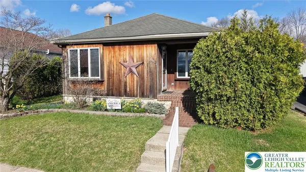 a aerial view of a house with a yard and a garage