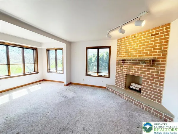 a view of an empty room with glass door