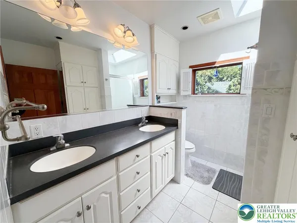 a bathroom with a sink double vanity and a mirror