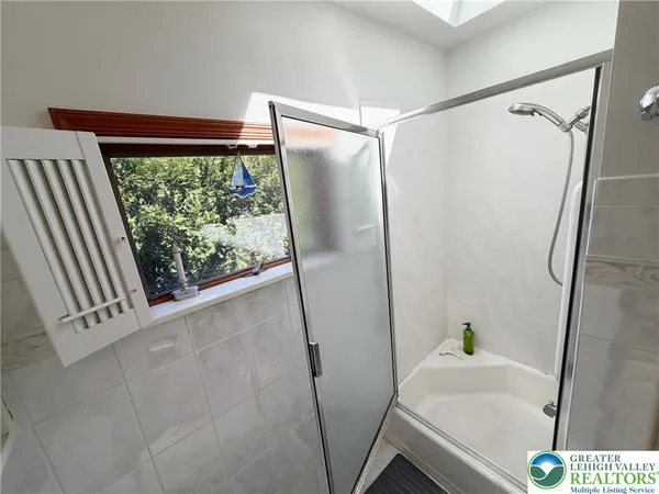 a bathroom with a sink and a large window