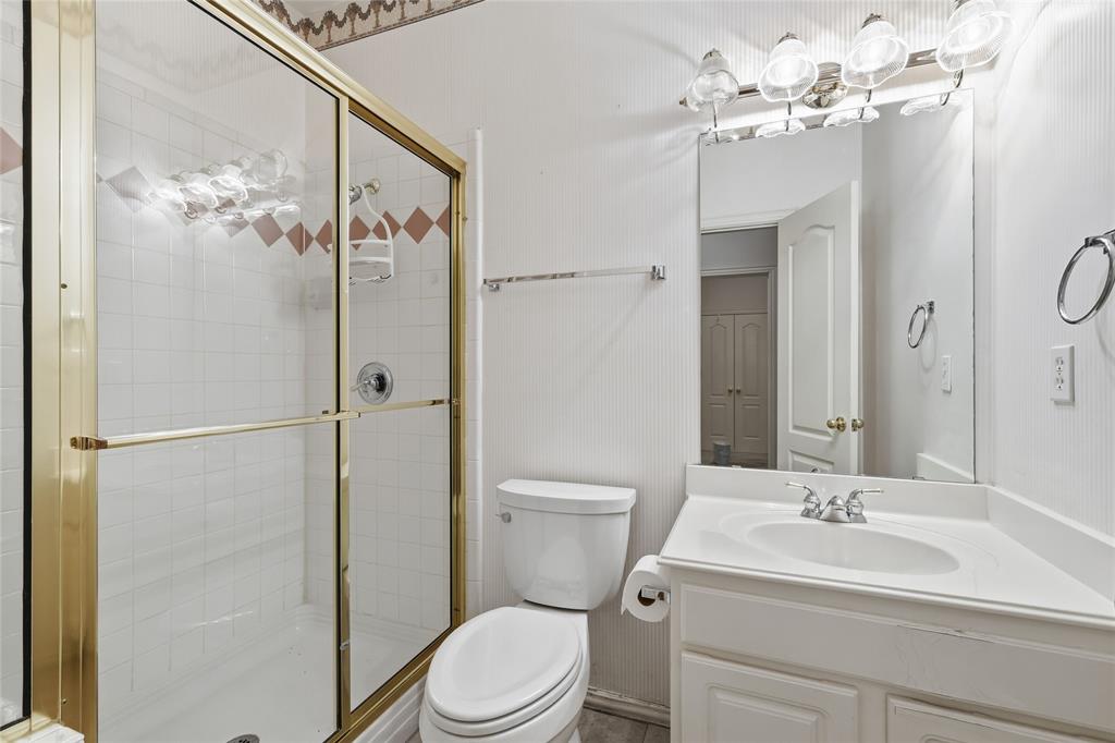 2216 Post Oak Court Corinth, TX 76210 - Photo 13 of 19 a bathroom with a toilet a sink and a mirror