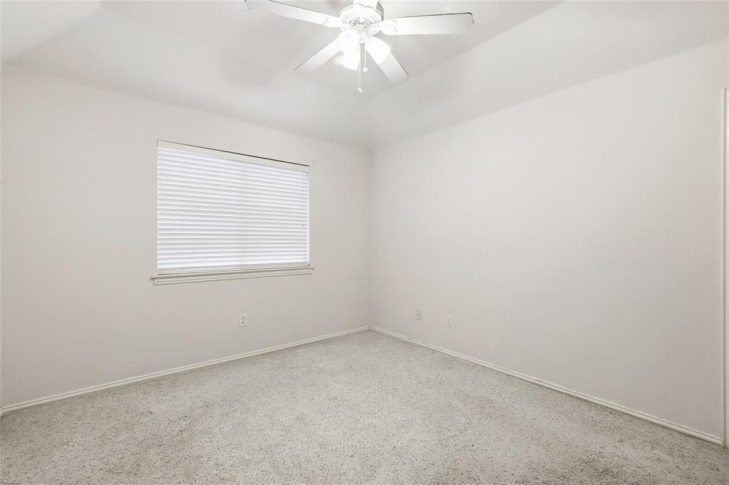 2216 Post Oak Court Corinth, TX 76210 - Photo 15 of 19 an empty room with a window and a ceiling fan