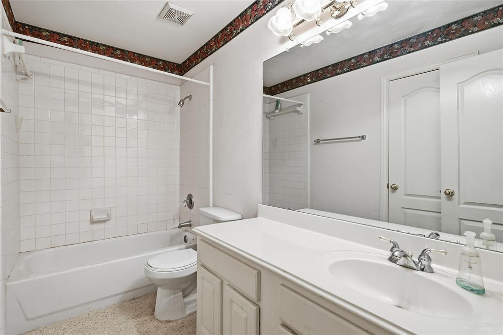 2216 Post Oak Court Corinth, TX 76210 - Photo 16 of 19 a bathroom with a sink a toilet and shower