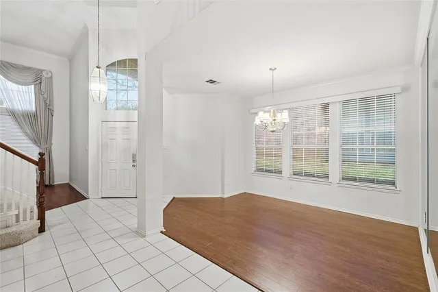 a large white kitchen with cabinets and stainless steel appliances