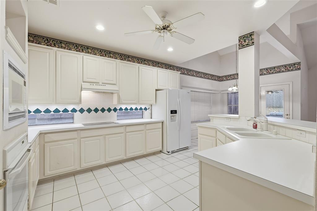 2216 Post Oak Court Corinth, TX 76210 - Photo 5 of 19 a large white kitchen with cabinets and stainless steel appliances