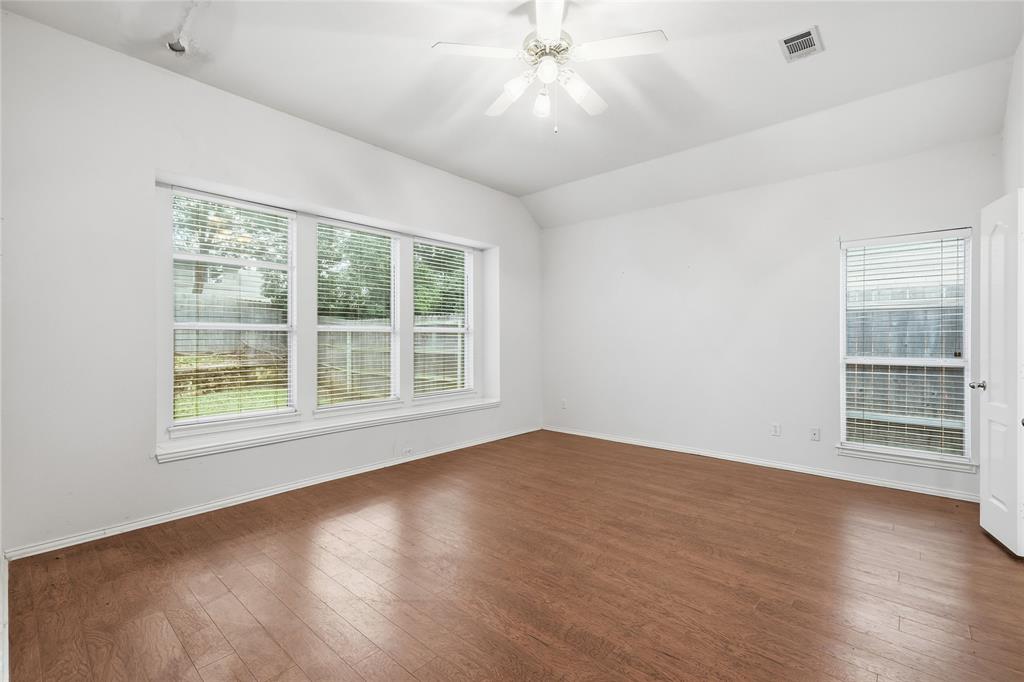 2216 Post Oak Court Corinth, TX 76210 - Photo 10 of 19 an empty room with wooden floor and windows