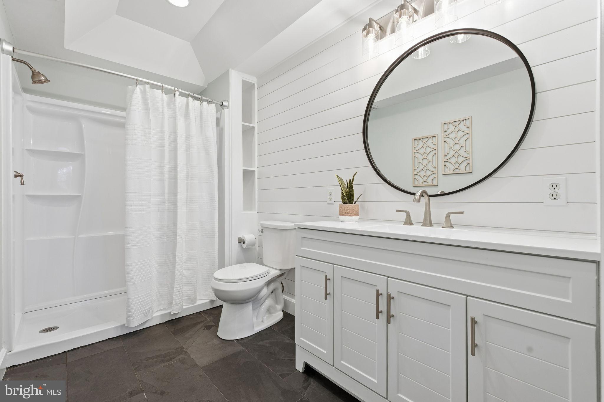 3135 Fait Avenue Baltimore, MD 21224 - Photo 16 of 35 a bathroom with a toilet a sink and a mirror