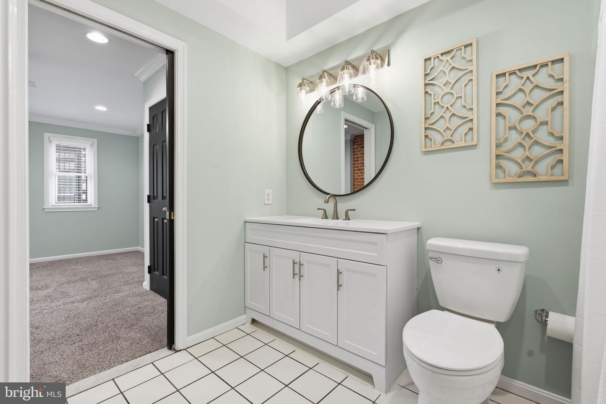 3135 Fait Avenue Baltimore, MD 21224 - Photo 21 of 35 a bathroom with a toilet sink vanity and mirror