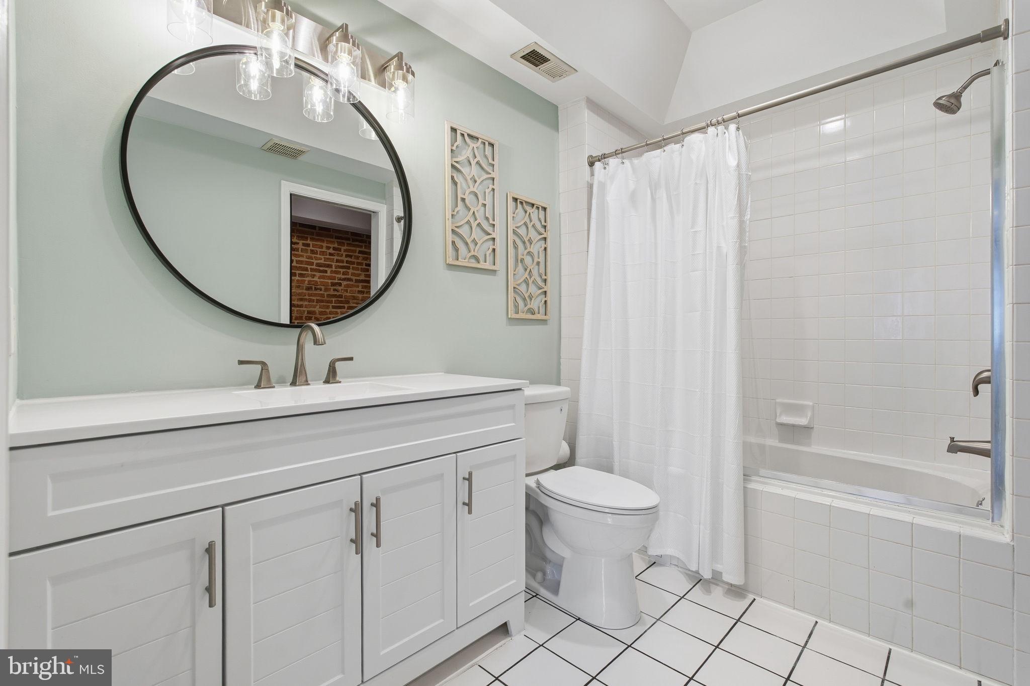 3135 Fait Avenue Baltimore, MD 21224 - Photo 22 of 35 a bathroom with a sink toilet and shower