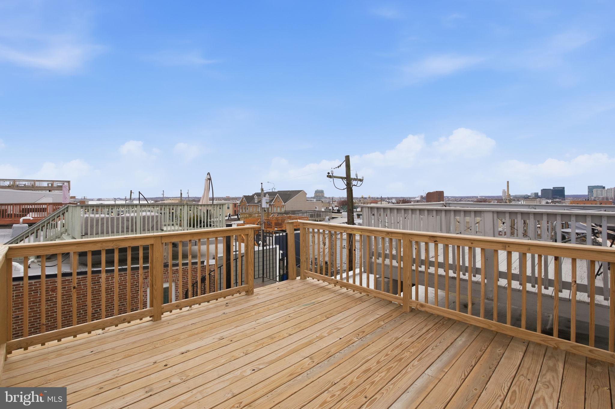 3135 Fait Avenue Baltimore, MD 21224 - Photo 31 of 35 a view of roof deck with two chairs and wooden floor
