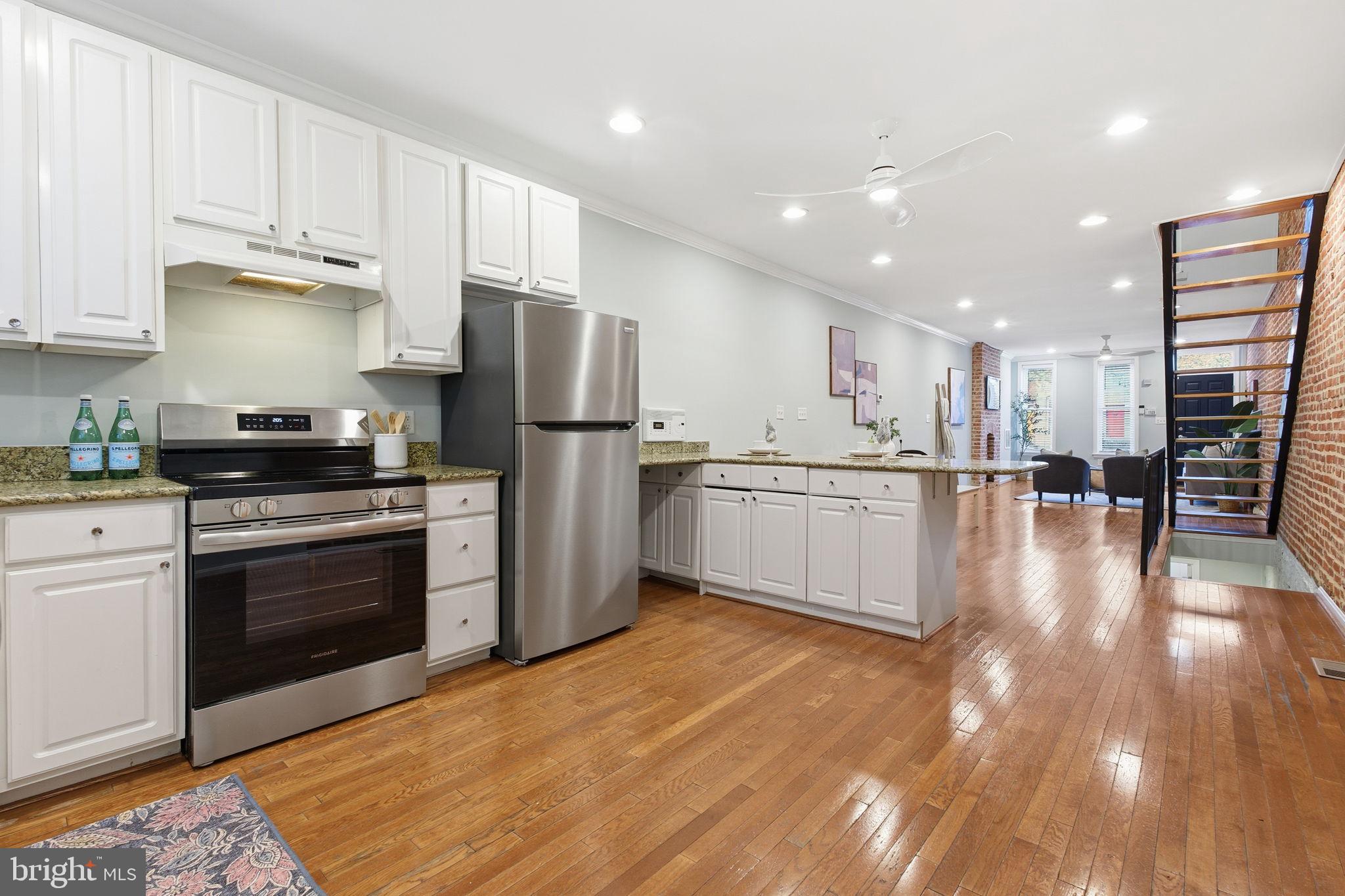 3135 Fait Avenue Baltimore, MD 21224 - Photo 5 of 35 a kitchen with stainless steel appliances granite countertop a refrigerator sink and stove