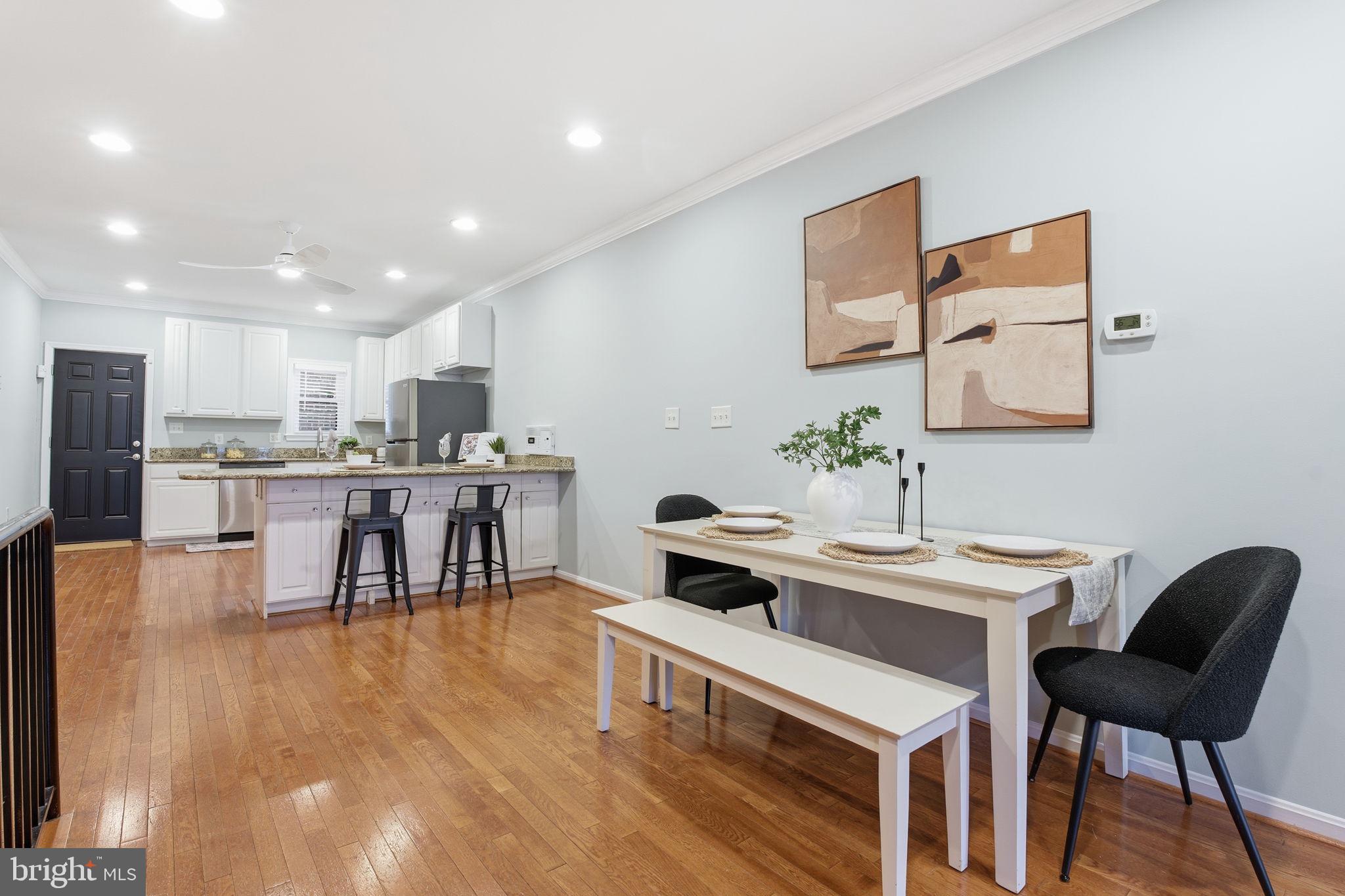 3135 Fait Avenue Baltimore, MD 21224 - Photo 9 of 35 a kitchen with kitchen island a dining table chairs stainless steel appliances and cabinets