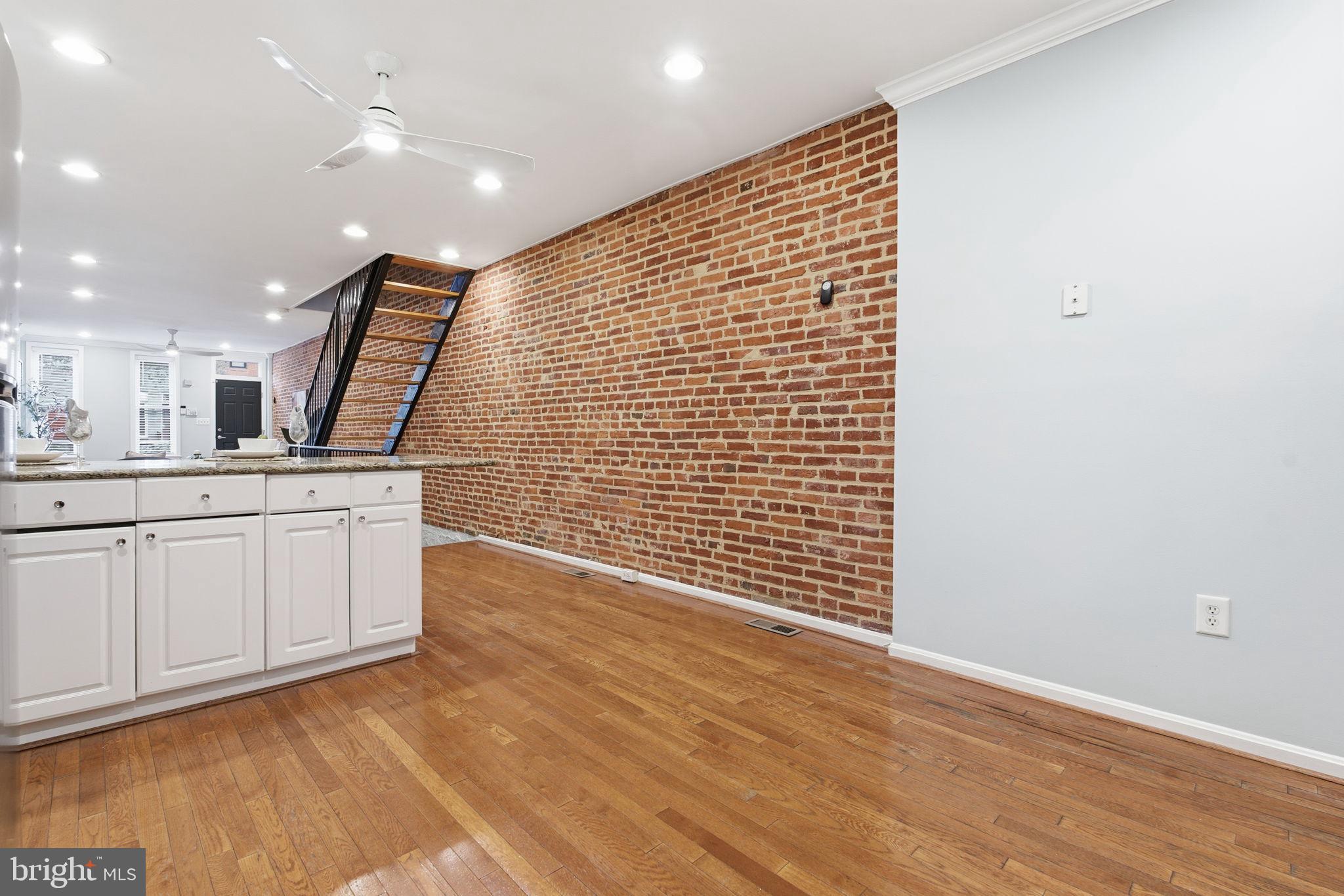 3135 Fait Avenue Baltimore, MD 21224 - Photo 10 of 35 a view of cabinets with wooden floor and window