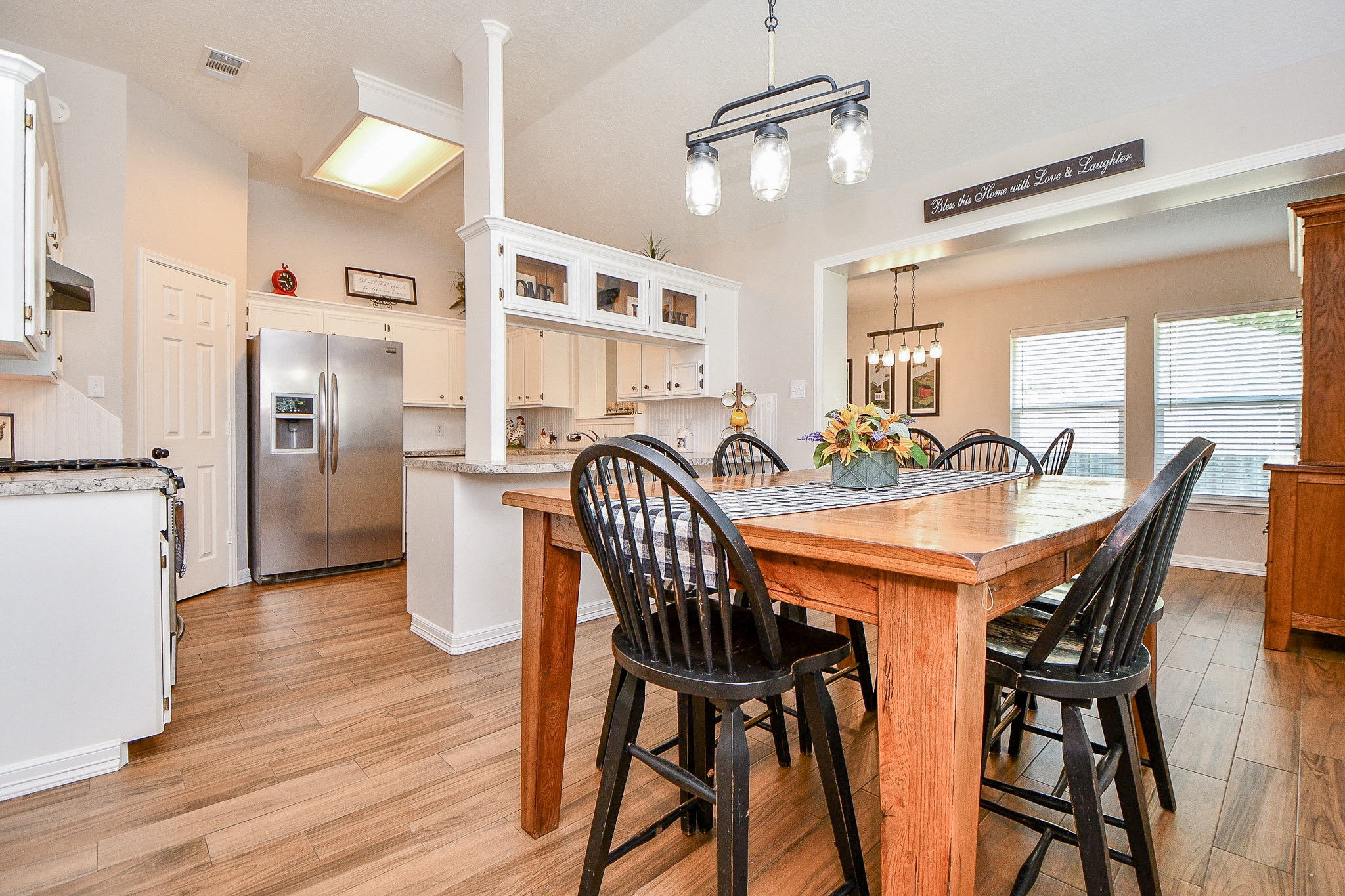 606 Walnut Street Sweeny, TX 77480 - Photo 9 of 28 The mason jar lighting adds a touch of nostalgia and the Breakfast Nook flows right into the Dining Room and Kitchen