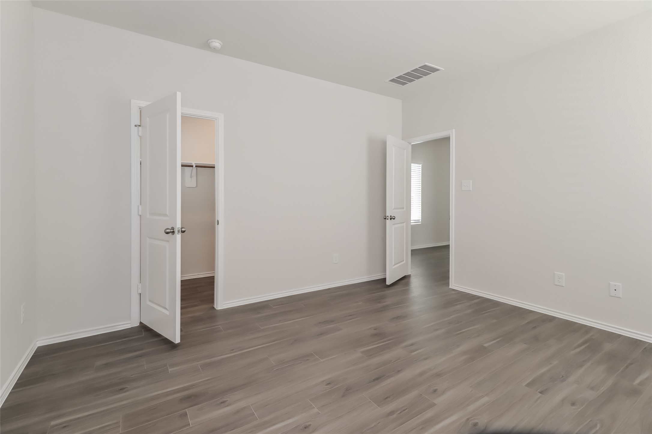 15345 Estrella Road East Houston, TX 77073 - Photo 7 of 13 a view of an empty room with wooden floor and a window
