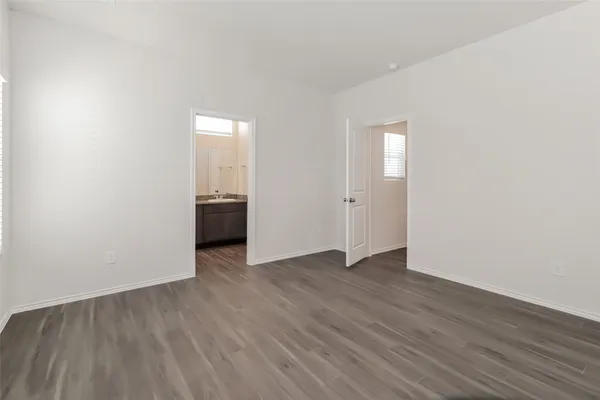 an empty room with wooden floor and closet