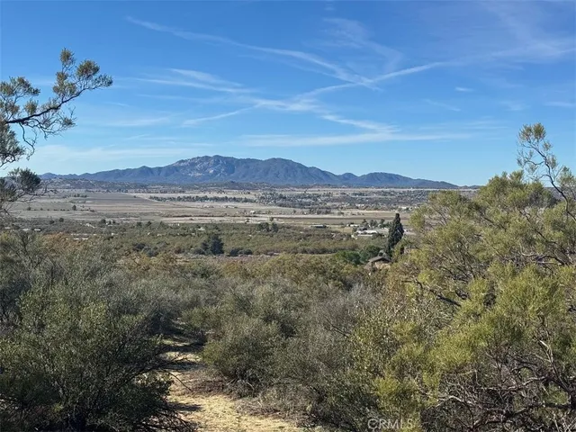 a view of a dry yard with mountains in the background