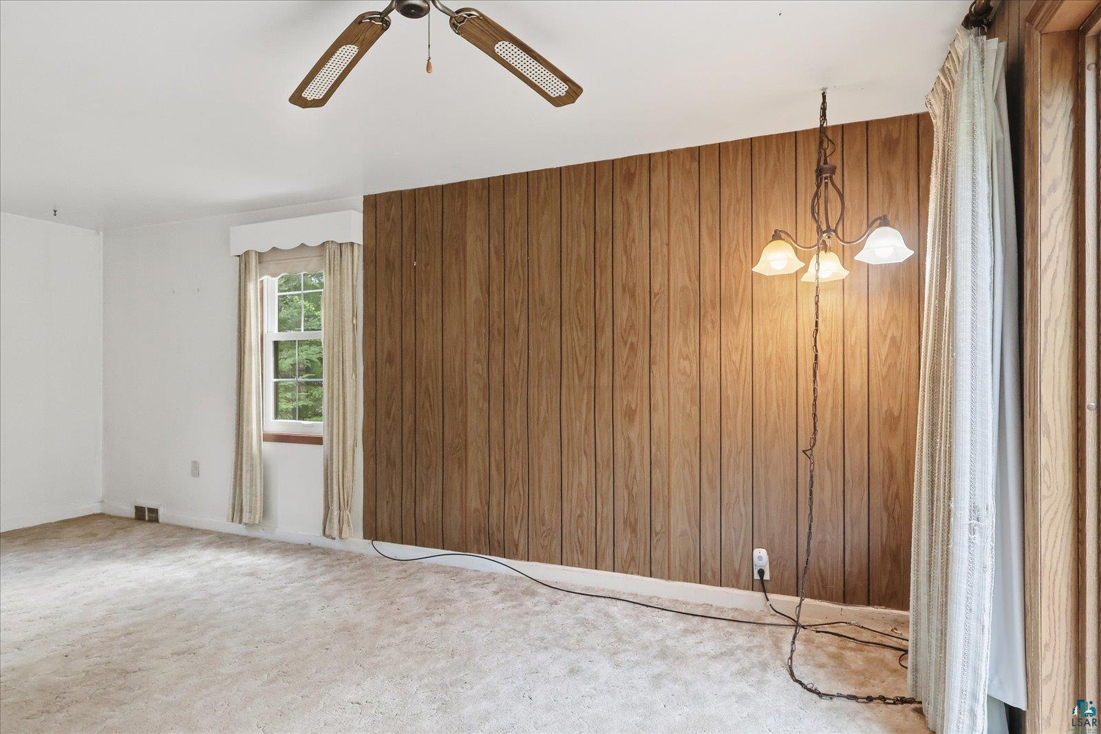 5192 Lavaque Junction Road Hermantown, MN 55811 - Photo 13 of 34 Interior room featuring wood paneling, wall-to-wall carpeting, and a window with trim