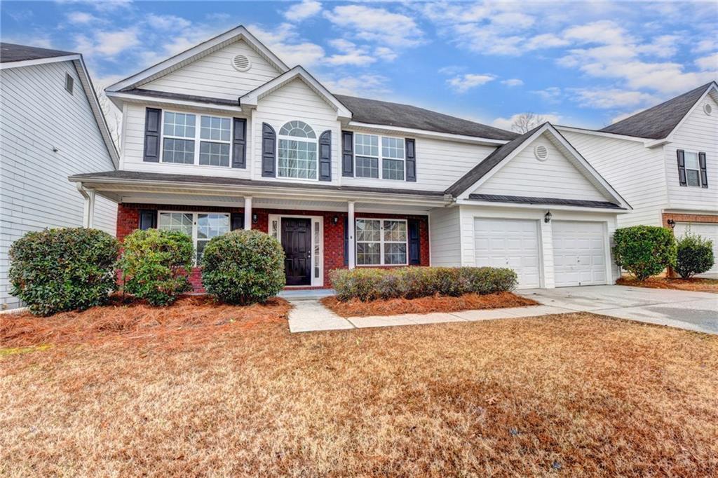 a front view of a house with a yard